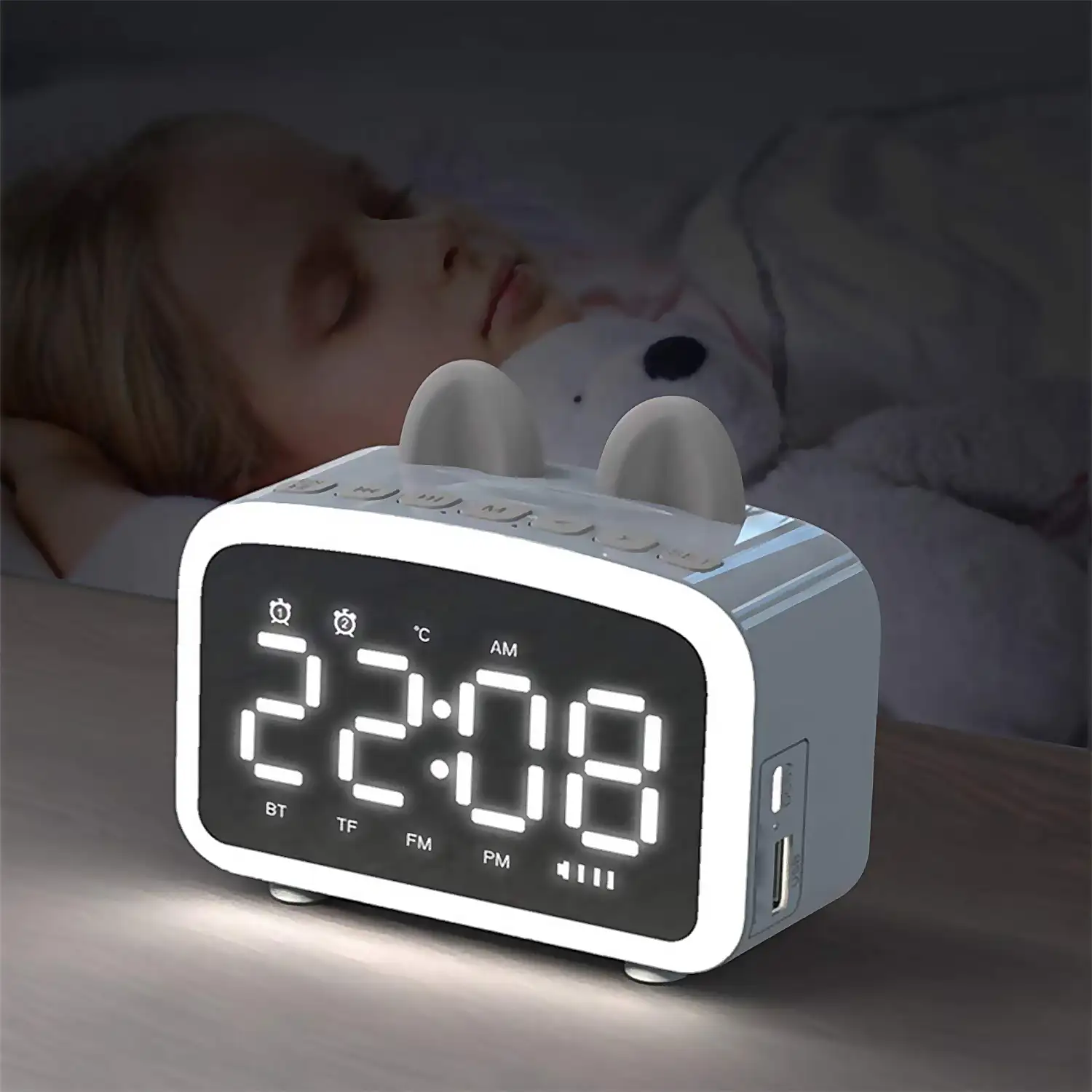 Reloj despertador LCD con luz nocturna, altavoz Bluetooth incorporado, termómetro, radio, soporte de smartphone. Batería recargable.